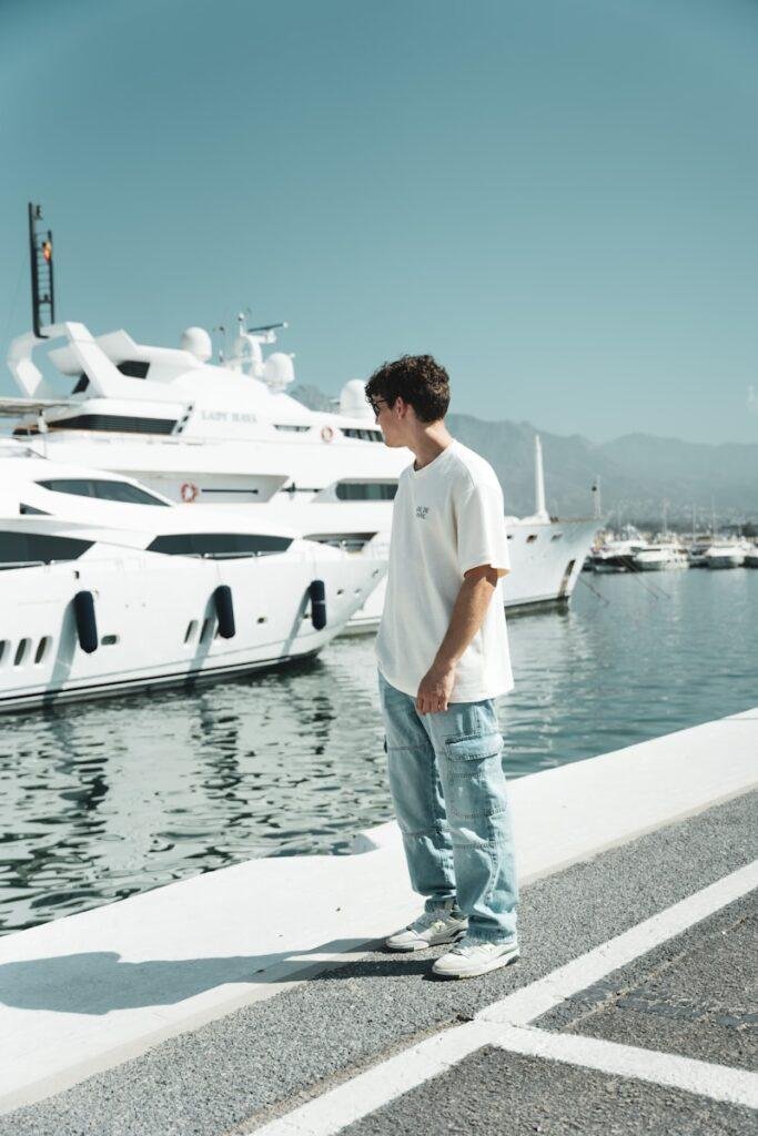 A man standing on a dock next to a boat